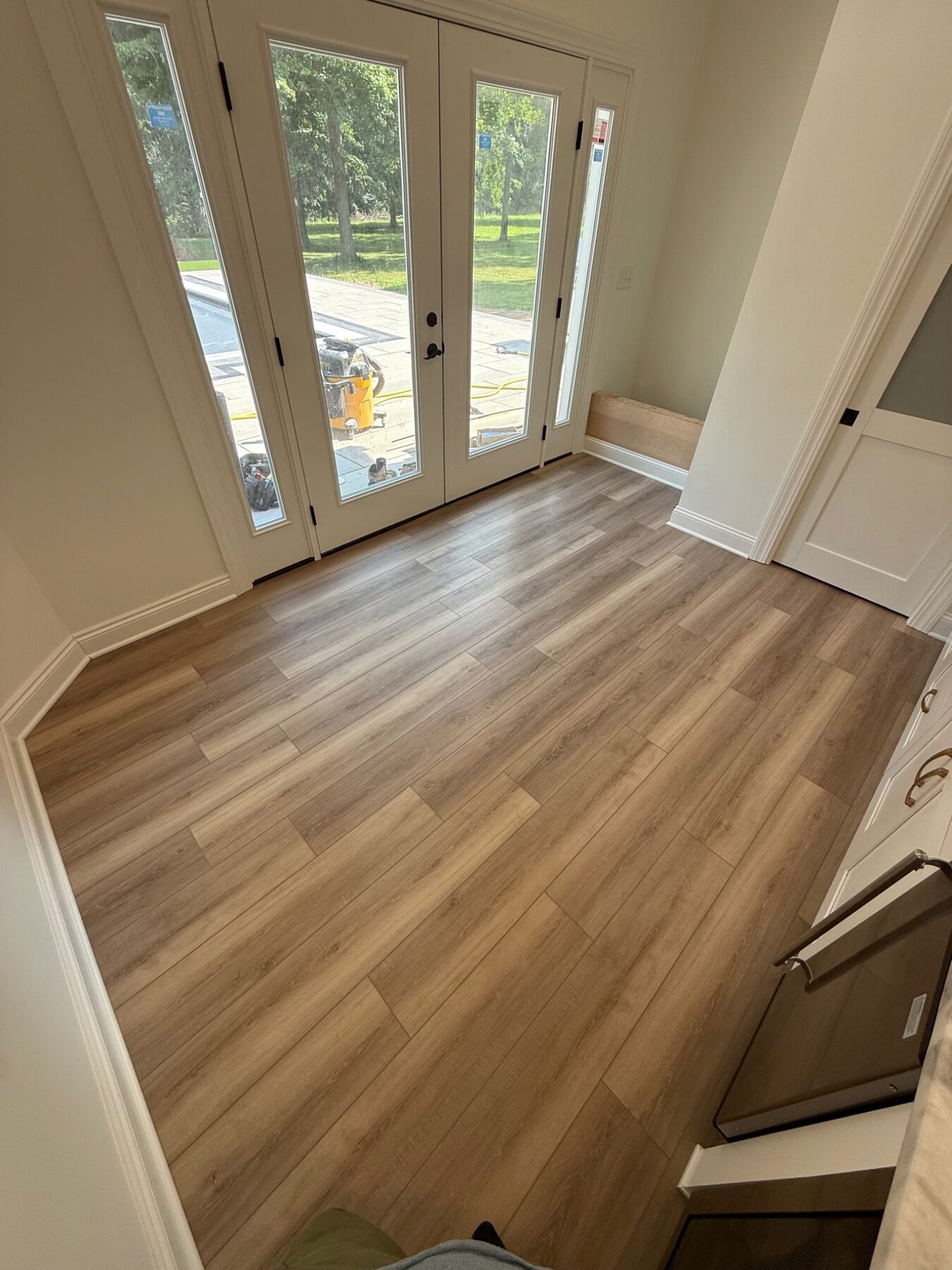 New plank flooring and trim in a bright entryway