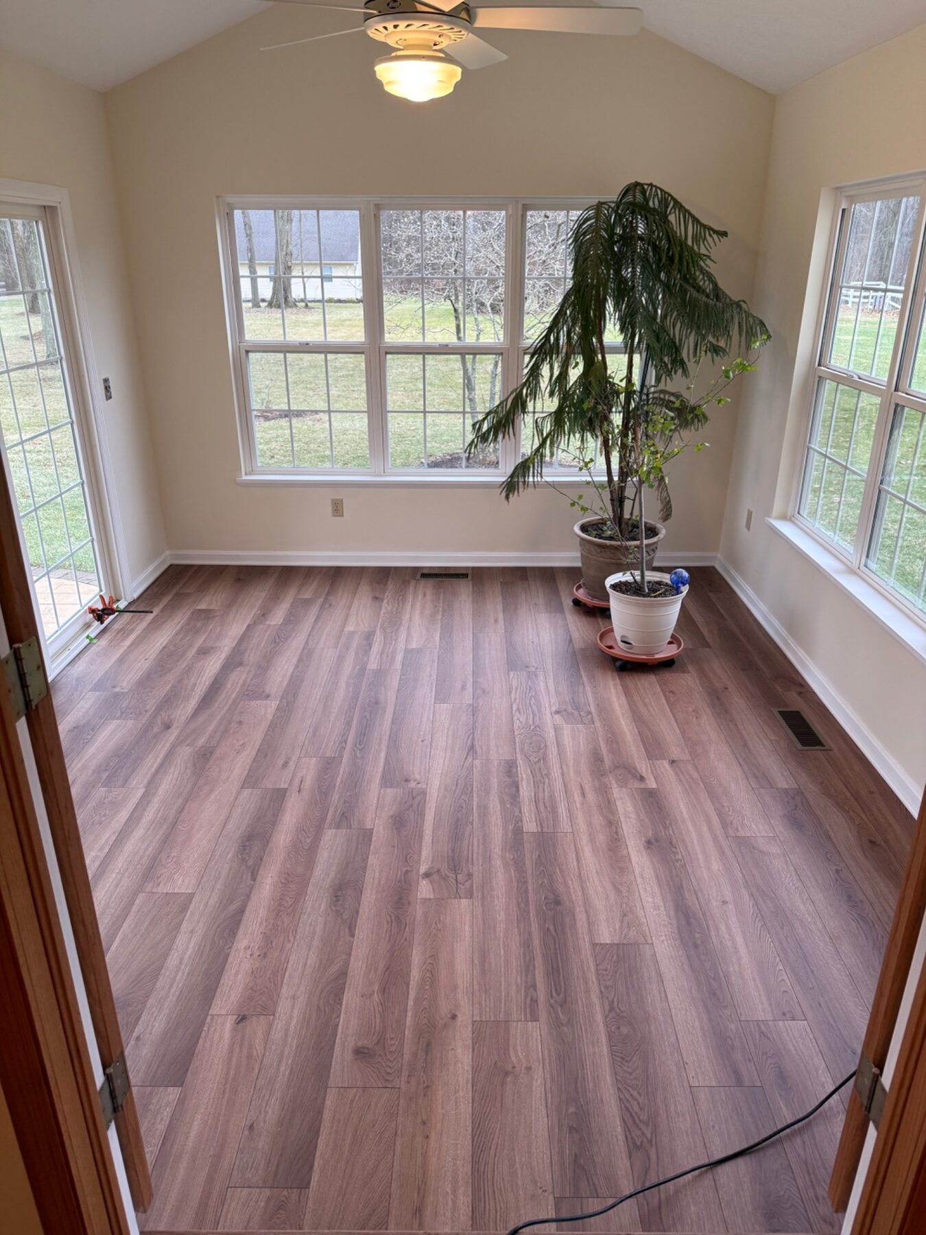 Finished wood-look flooring in a bright sunroom